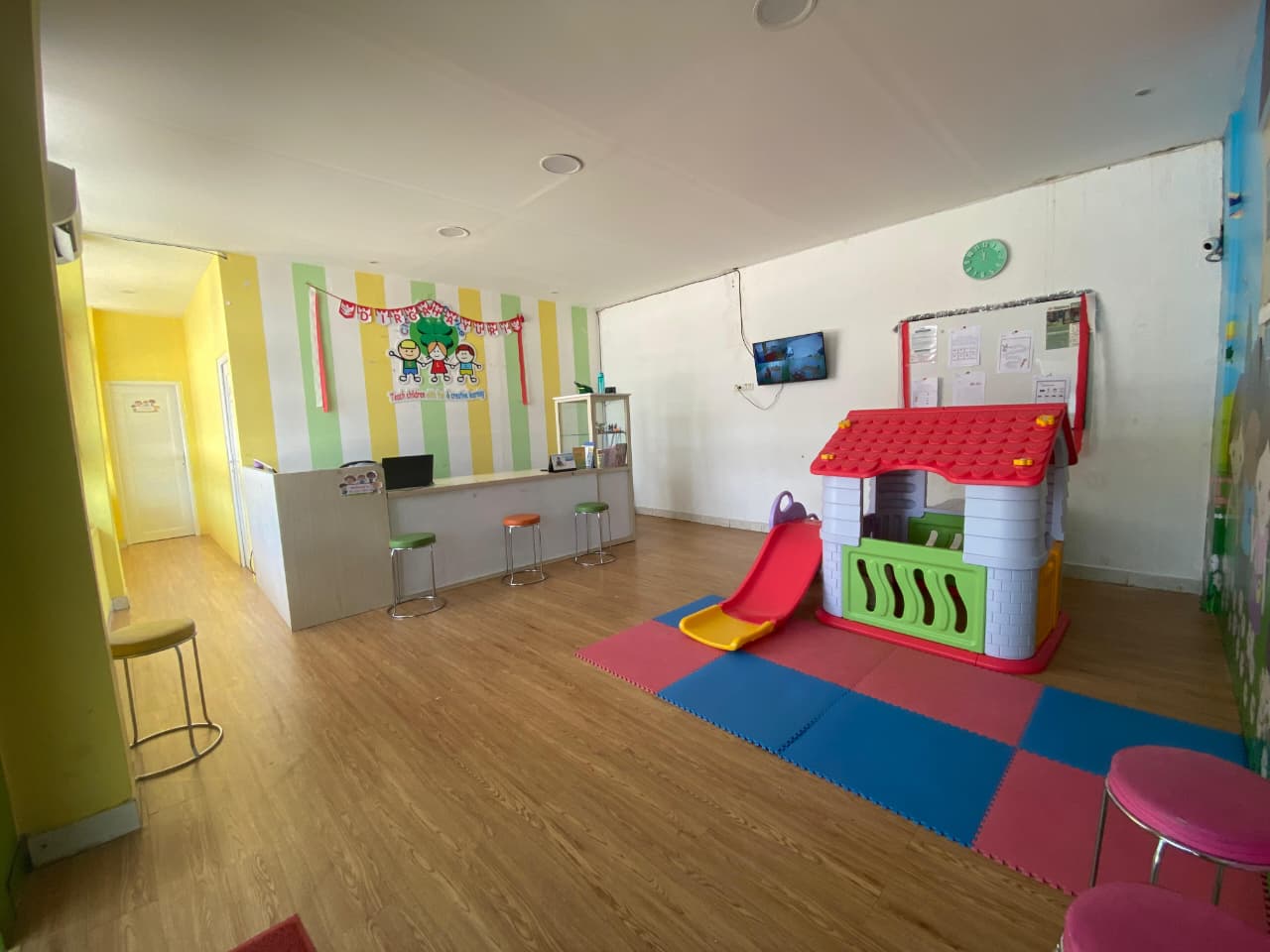 cartoon style modern kids learning center in a mall setting in Jakarta, bright and colorful