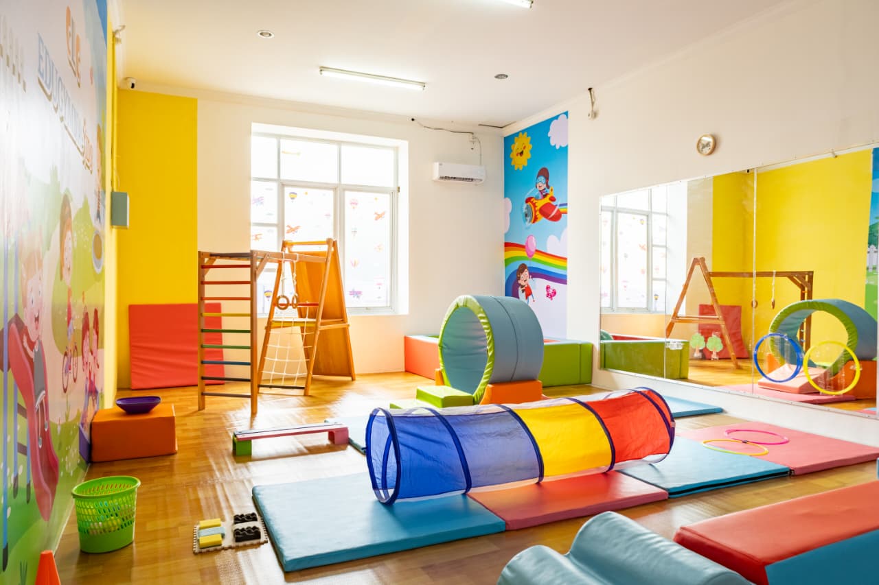 cartoon style modern kids learning center in a mall setting in Jakarta, bright and colorful