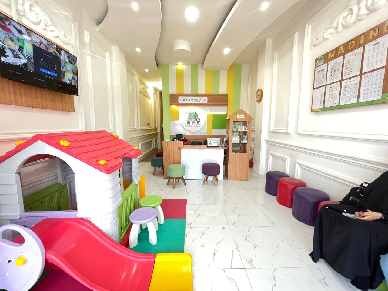 cartoon style modern kids learning center in a mall setting in Jakarta, bright and colorful