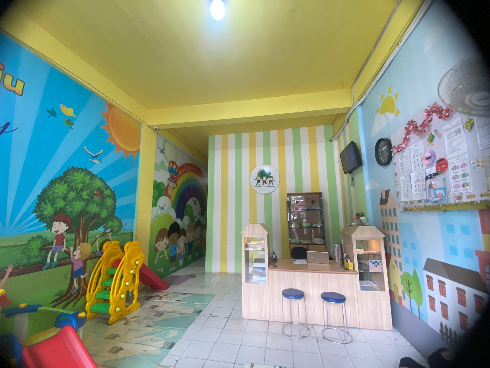cartoon style modern kids learning center in a mall setting in Jakarta, bright and colorful