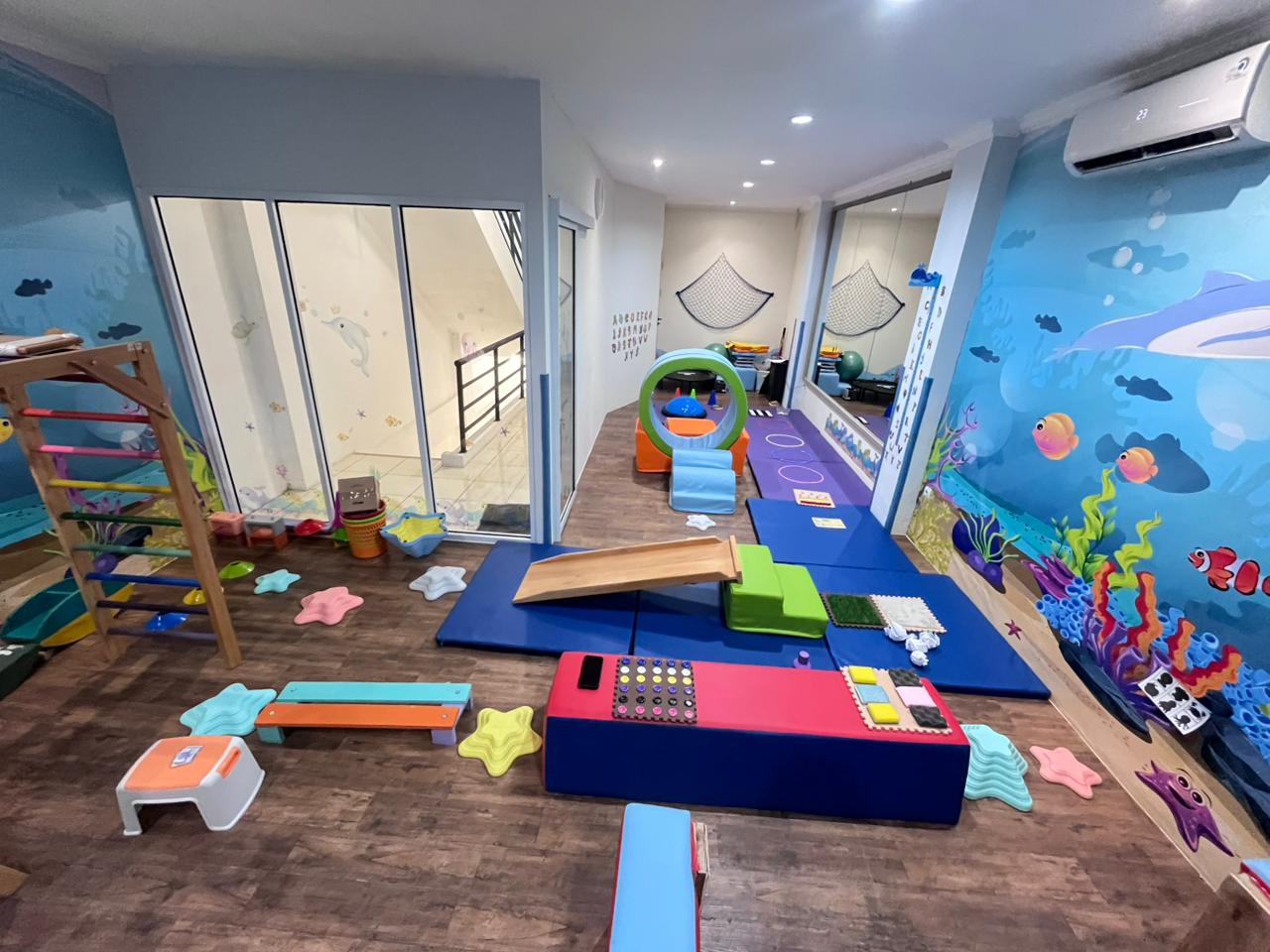 cartoon style modern kids learning center in a mall setting in Jakarta, bright and colorful