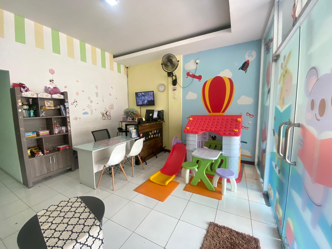 cartoon style modern kids learning center in a mall setting in Jakarta, bright and colorful