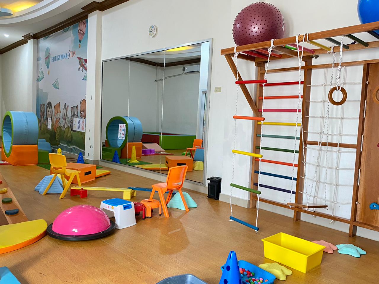 cartoon style modern kids learning center in a mall setting in Jakarta, bright and colorful