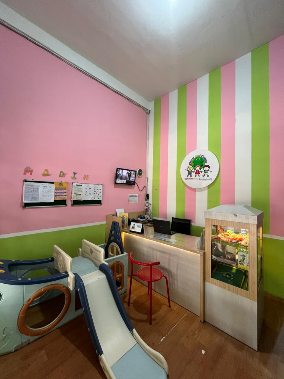 cartoon style modern kids learning center in a mall setting in Jakarta, bright and colorful